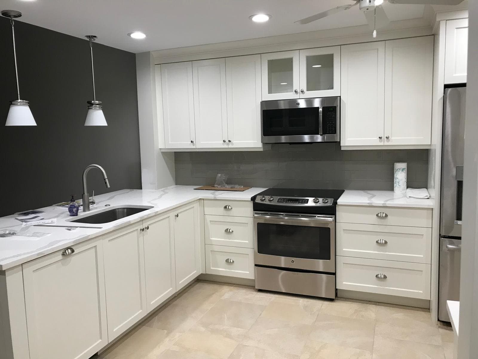 White kitchen remodel with accent wall - Master Cabinets